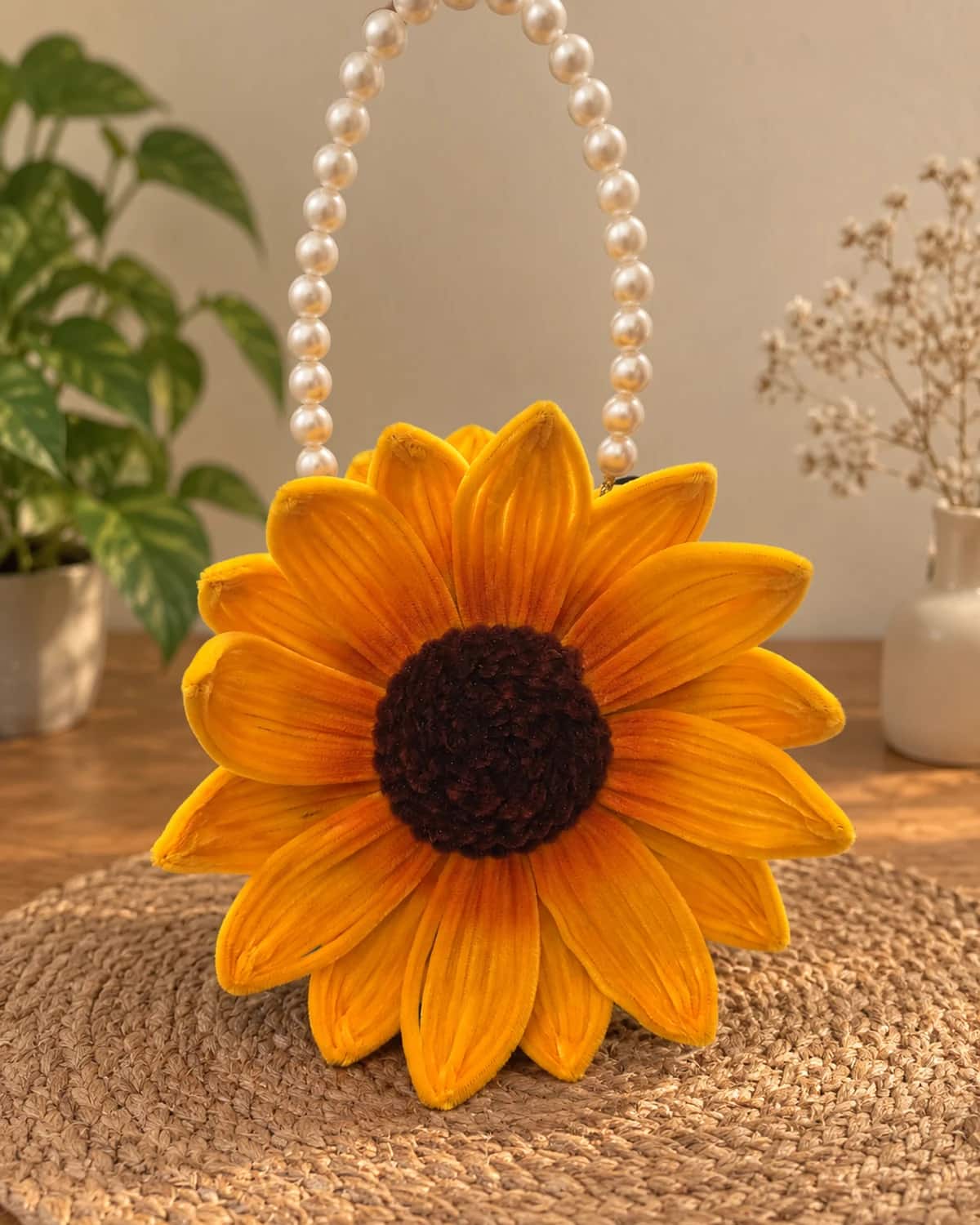 handmade chenille sunflower handbag with a pearl bead top handle, a second bloom, and two red chenille cherries on a green stem — a flower-shaped purse for a mehendi or wedding function