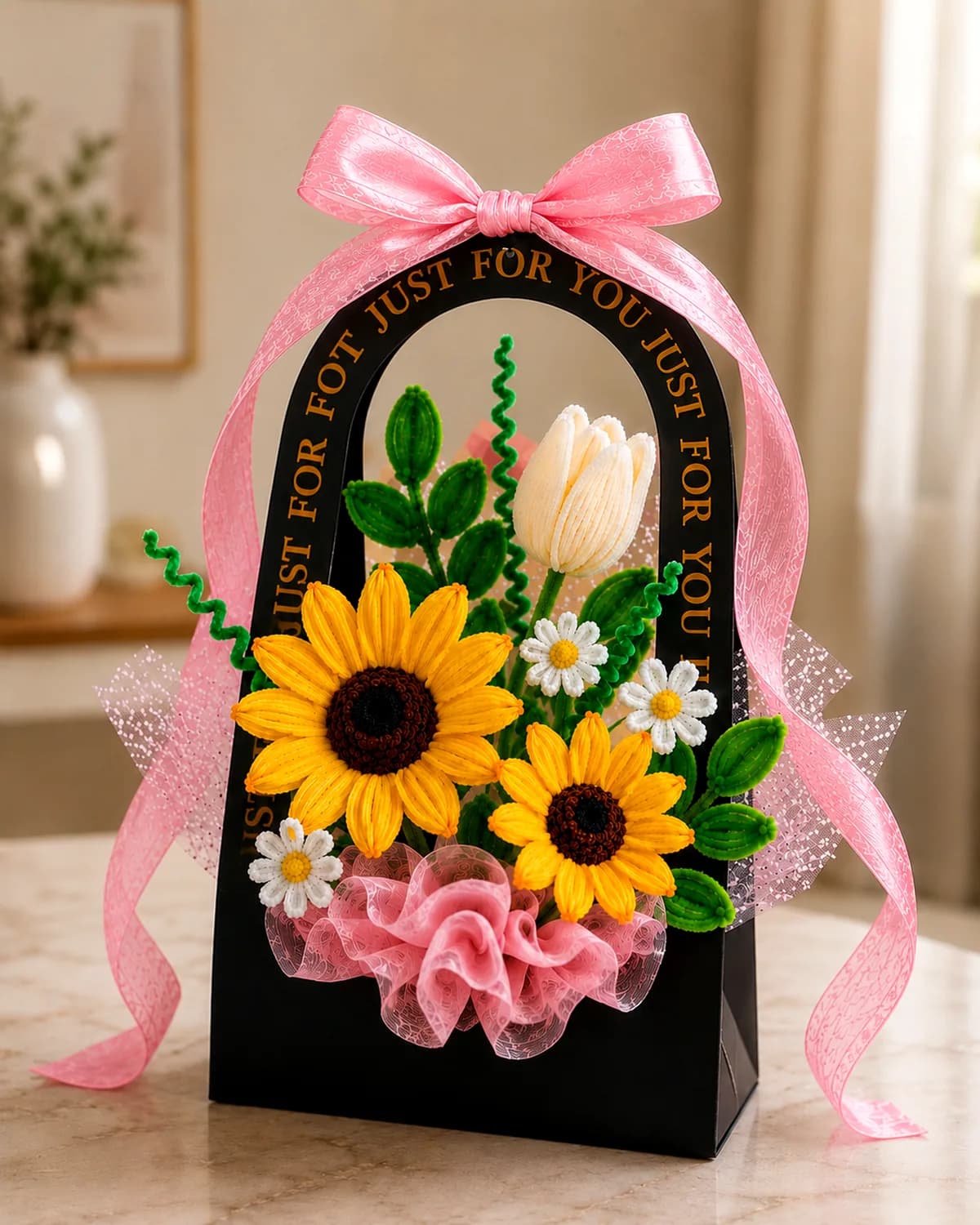 handmade pipe-cleaner flowers standing in an arched gift bag with a ribbon bow