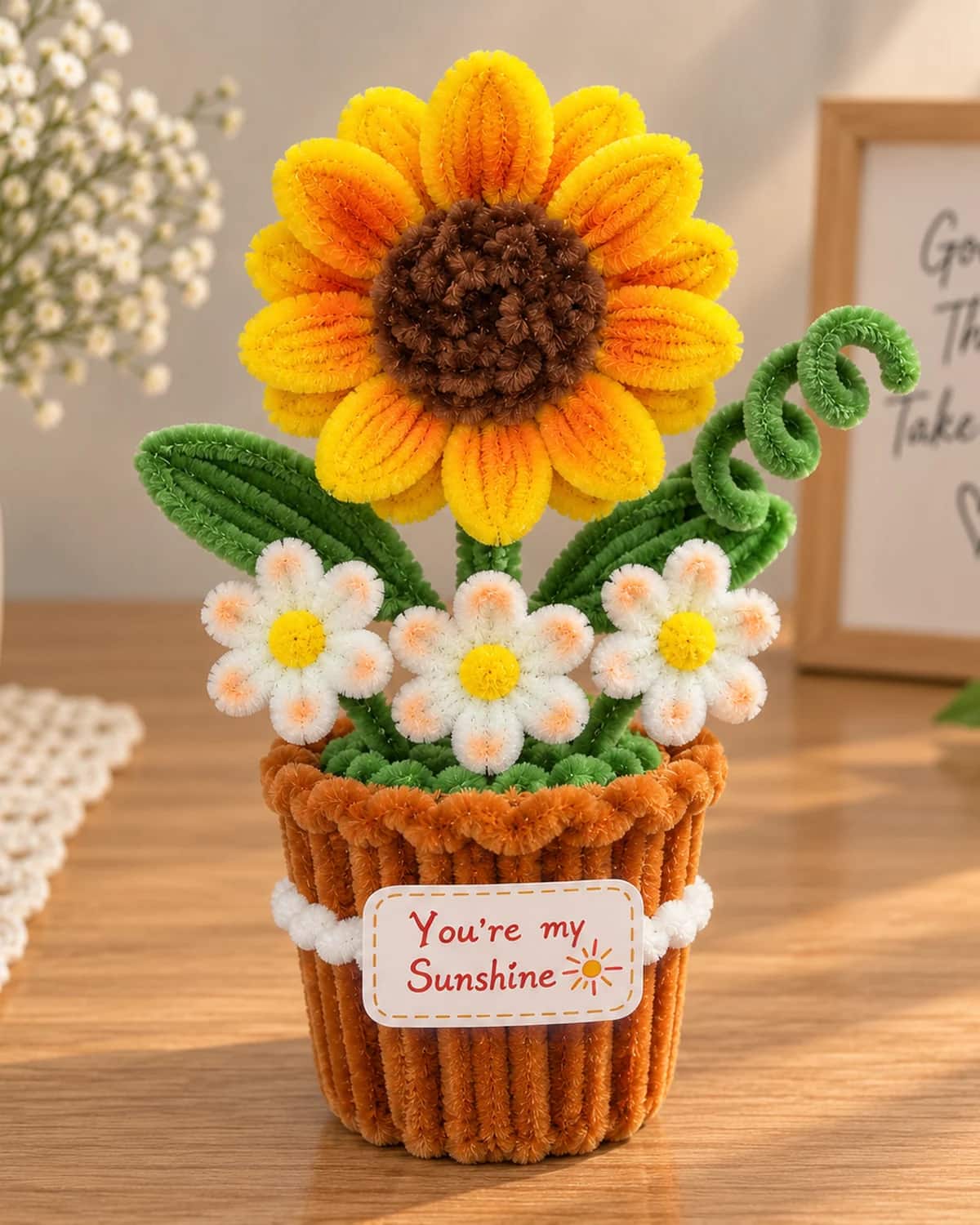 handmade chenille flower standing in a small woven chenille pot tied with a bow