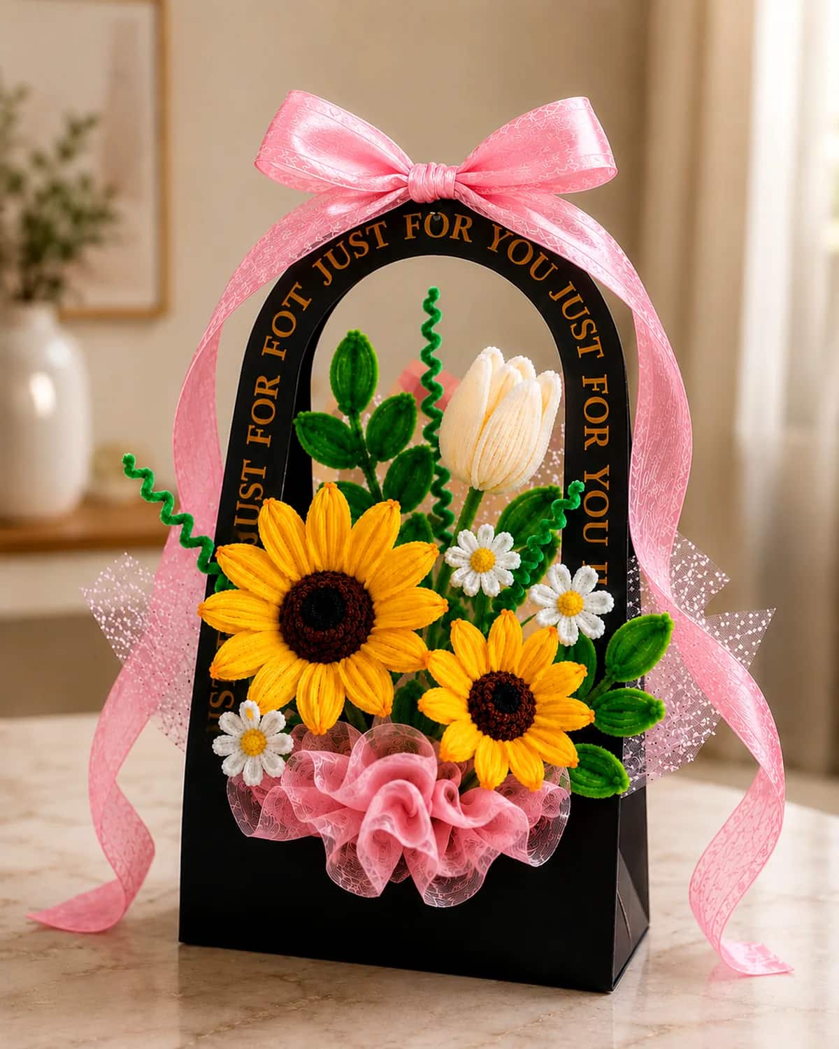 handmade pipe-cleaner flowers standing in an arched gift bag with a ribbon bow