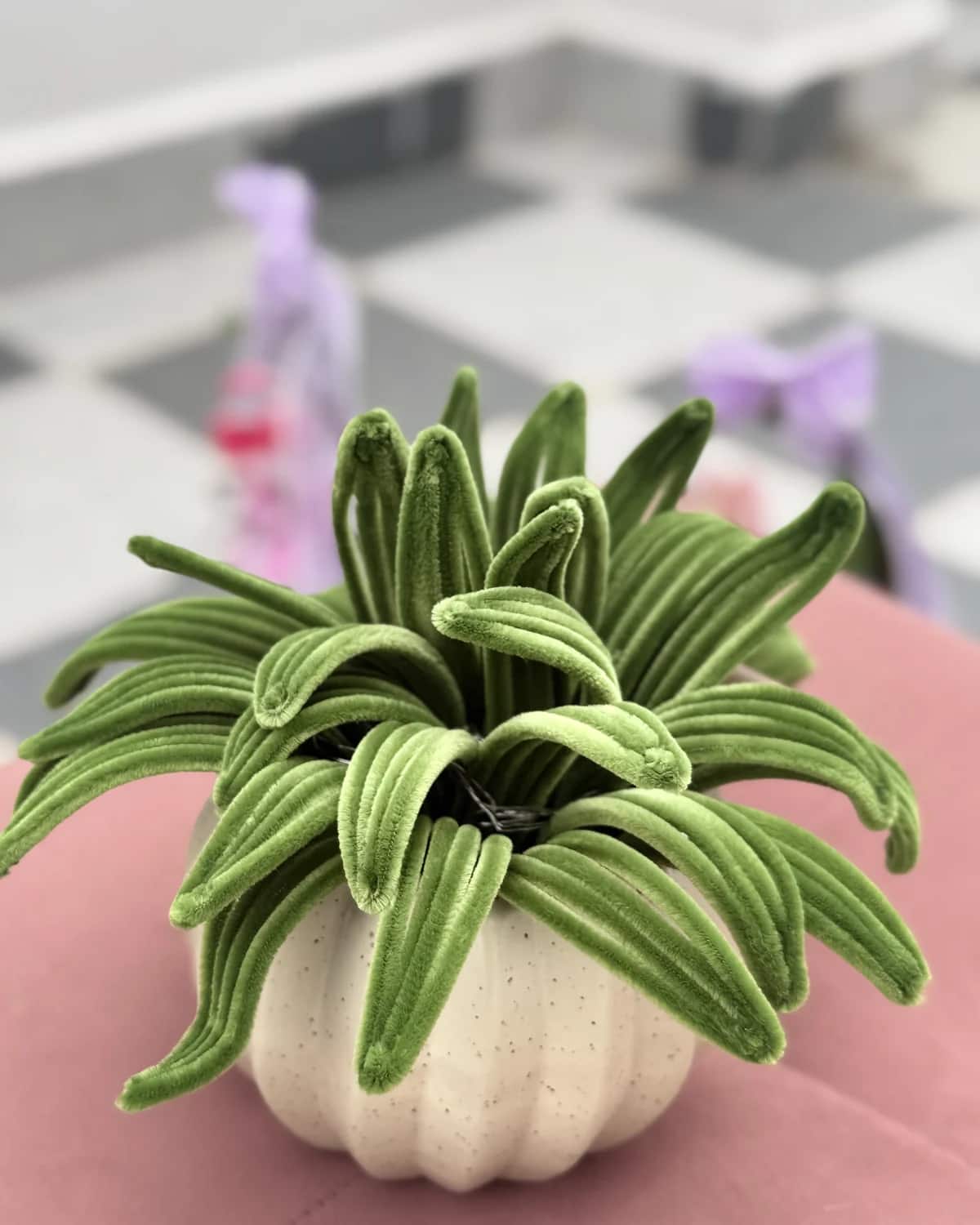 handmade chenille spider plant with long green leaves, planted in a cream ceramic pumpkin pot