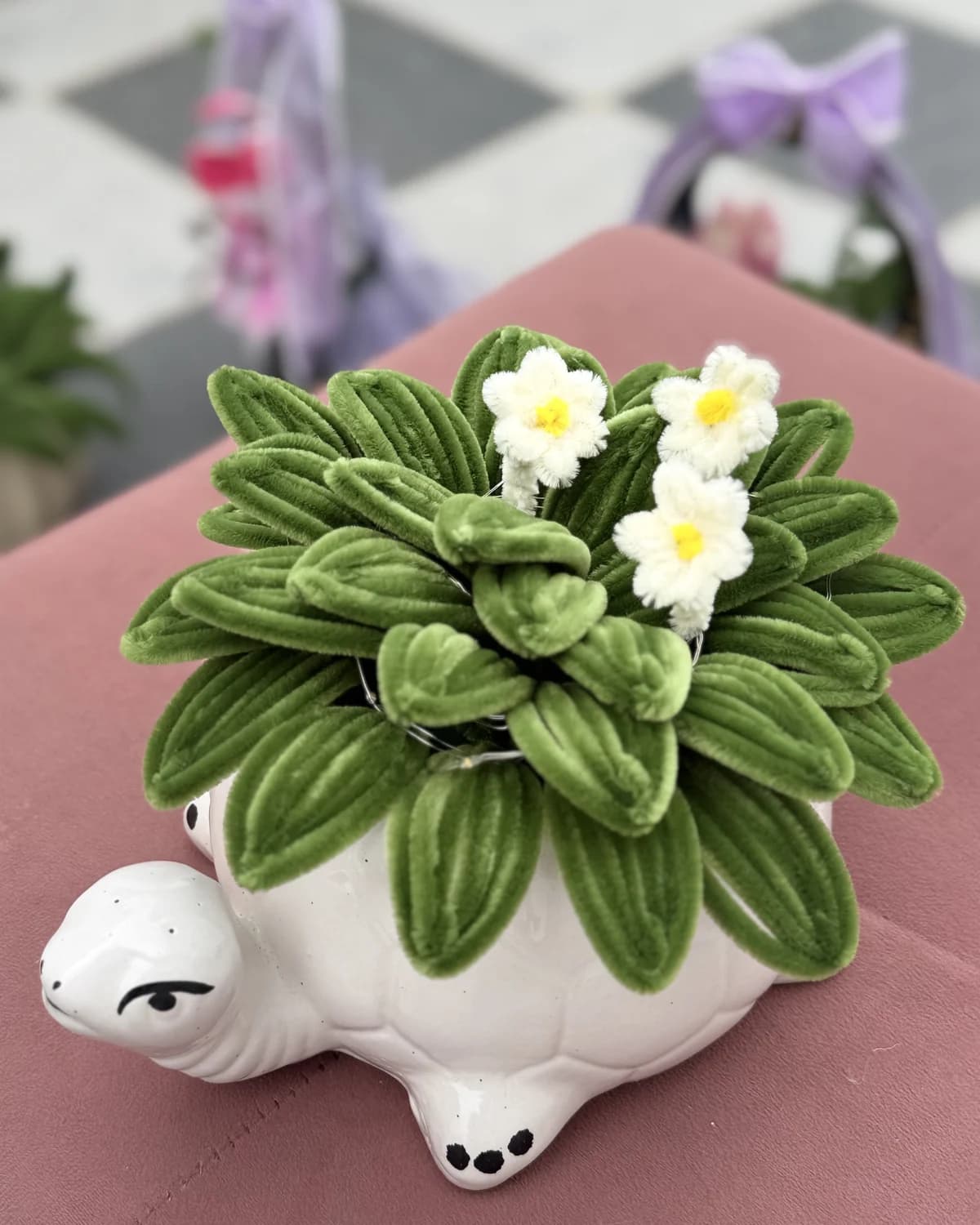 handmade chenille succulent with small white flowers, planted in a white ceramic turtle pot, view 2
