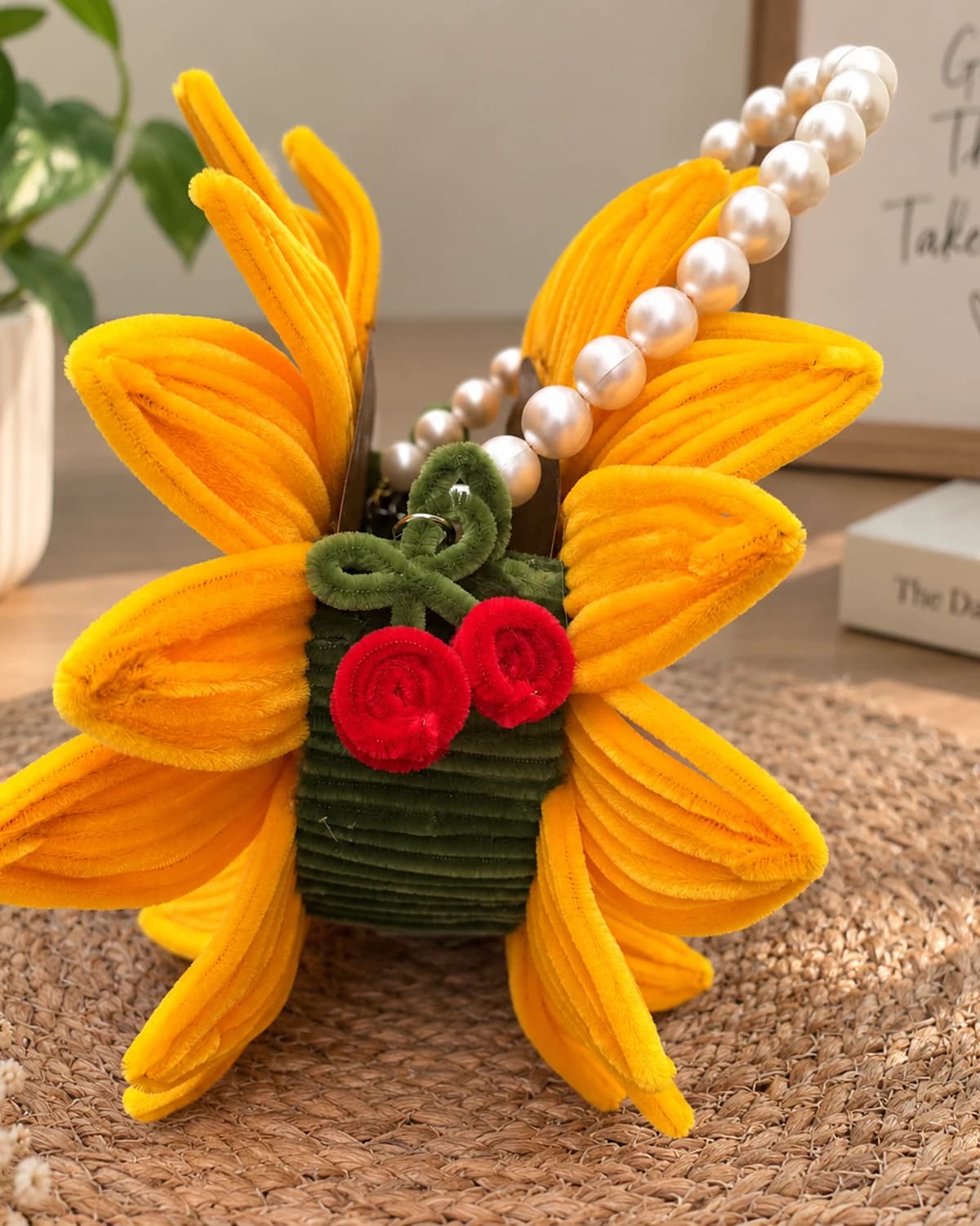 handmade chenille sunflower handbag with a pearl bead top handle, a second bloom, and two red chenille cherries on a green stem — a flower-shaped purse for a mehendi or wedding function, view 4